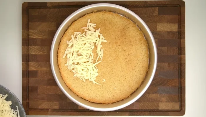 Layer half the low-moisture mozzarella in the center of the pre-baked kunafa, leaving a 1cm border. Top with the fresh mozzarella, then the remaining low-moisture mozzarella.
