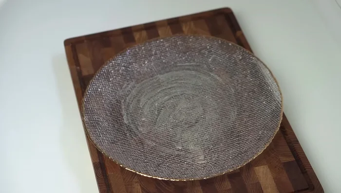 Grease a serving plate with clarified butter. Invert the cake pan onto the plate to release the kunafa.