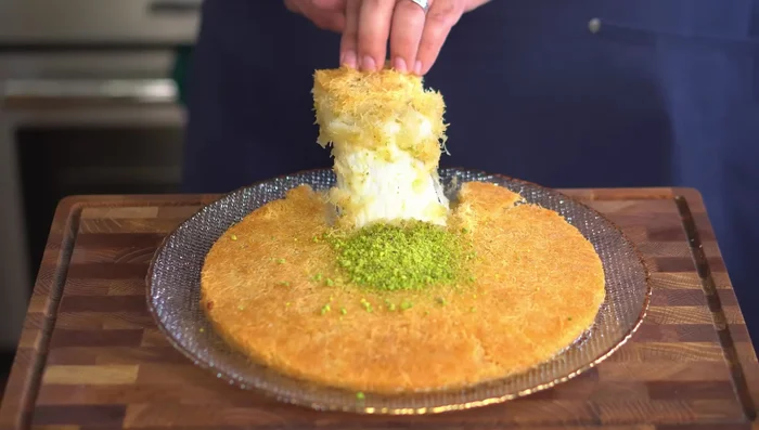 Garnish with ground pistachio and serve immediately.