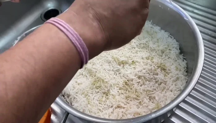 Add 1 teaspoon cardamom powder and 1-1.5 tablespoons rose water to the rice.