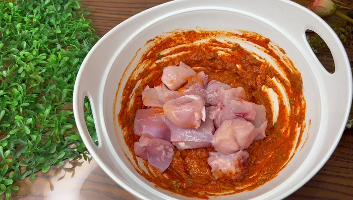 Add the chicken pieces to the batter and marinate for half an hour.
