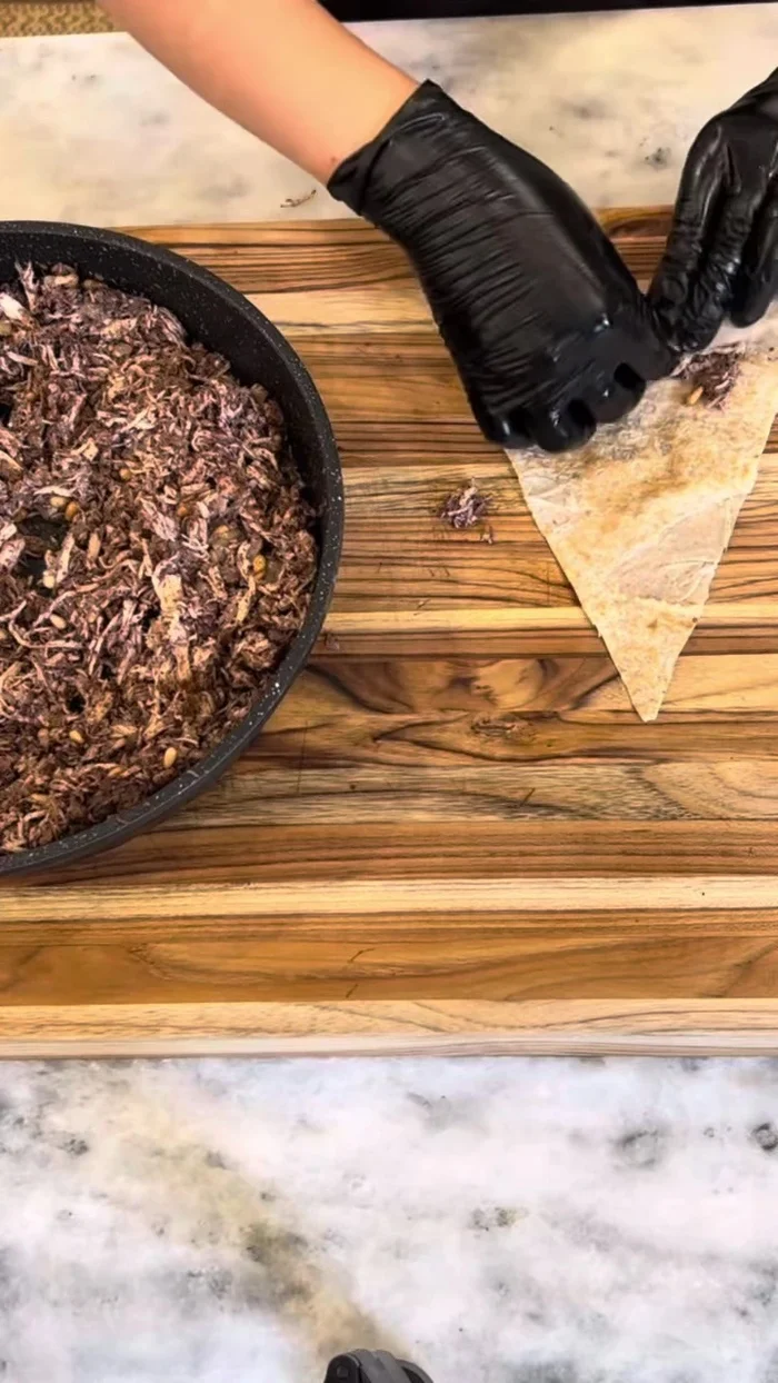 Add the chicken mixture to the bread triangles and roll them up.