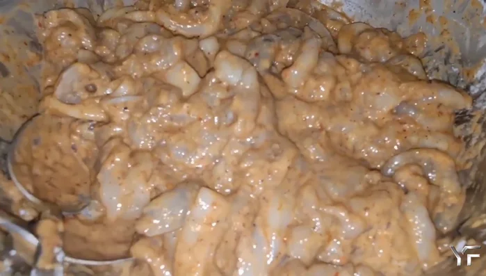 Coat the shrimp and calamari in the marinade and prepare for cooking.