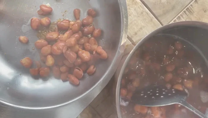 Transfer the fava beans (and a little of their water) to a bowl.