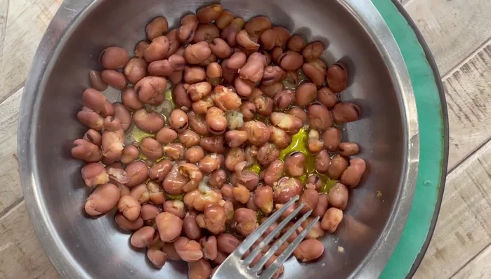 Mash some of the beans with a fork, leaving some whole.