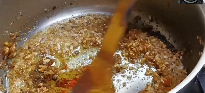 Add Arbi masala (refer to description box for details). Mix well, add water, and then add chopped tomatoes or tomato paste.