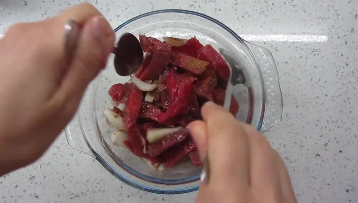 Pour the marinade over the beef and onions. Mix well.