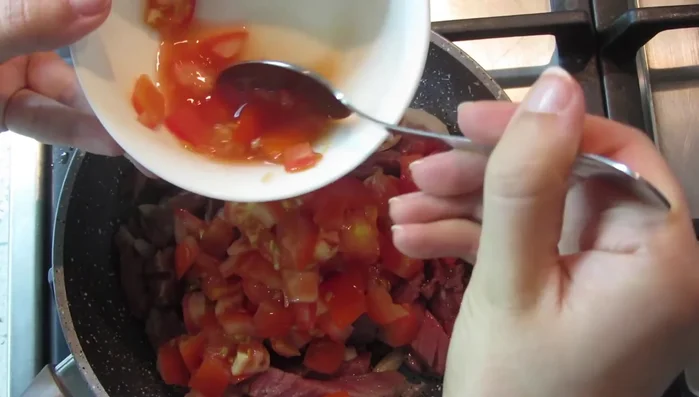 Add the chopped tomatoes and continue cooking until the meat is tender and the sauce has thickened, stirring occasionally.