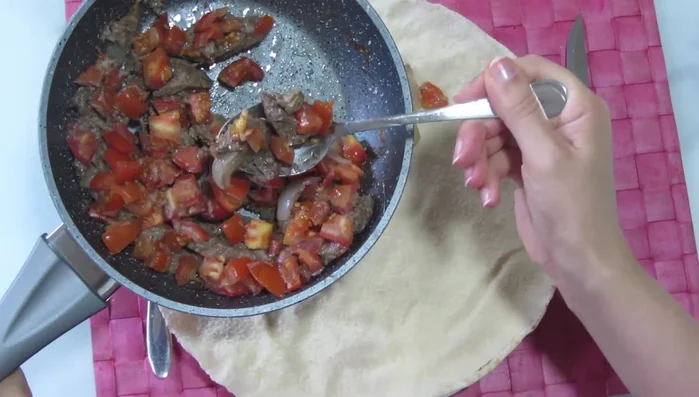 Place the cooked shawarma meat inside a Lebanese bread (or your preferred bread).