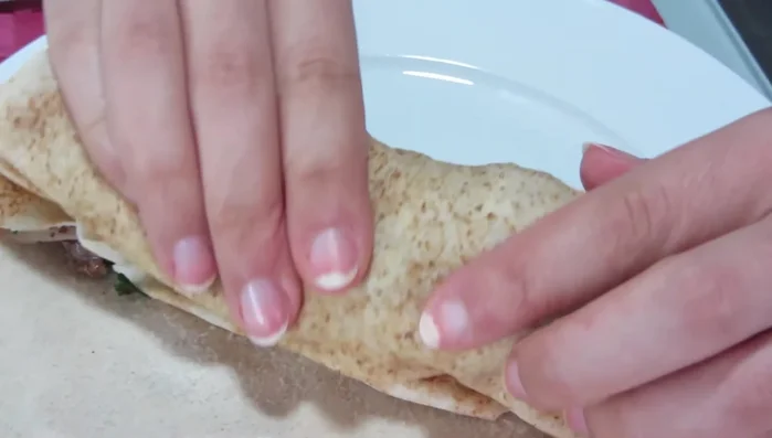 Fold the sandwich and serve.