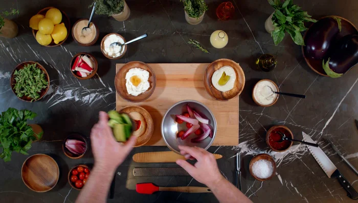 Prepare your crudités: toss cherry tomatoes, red Belgian endive, Persian cucumbers, and French breakfast radish with olive oil, lemon juice, and sea salt.