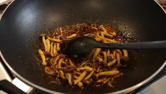 Add the pre-cooked beef to the sauce and stir to coat.