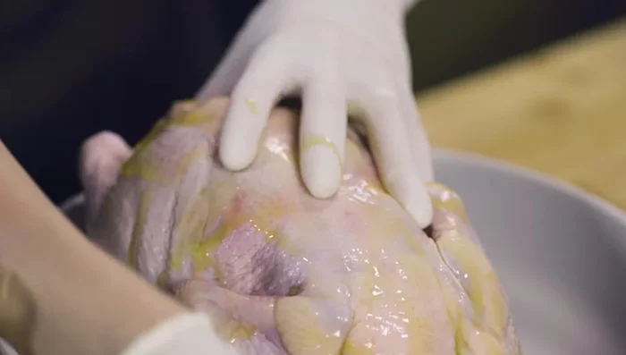 Drizzle olive oil over the chicken, rub it well. Sprinkle pepper and salt, rubbing it well into the chicken cavity.