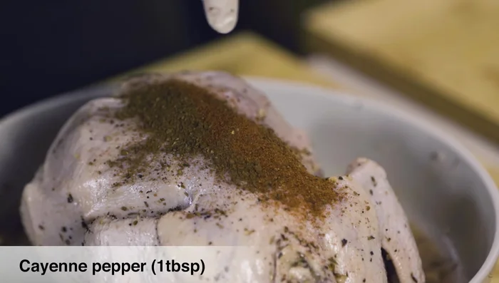 Season the chicken with seven spices, cayenne pepper, sumac, freshly ground coarse pepper, zaatar, a pinch of salt, paprika, and garlic granules.