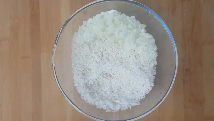 In a bowl, combine rice, ¾ of the salt, most of the pepper, and diced onion. Mix well.