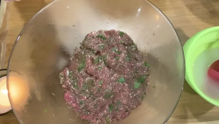 Roll a portion of the beef mixture between your hands, using a straw to create a round kofta shape. Pour onion juice over the koftas to enhance flavor.