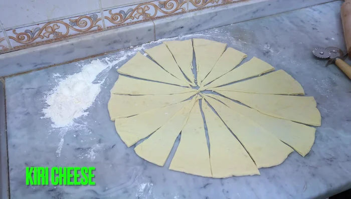 Place a piece of curry cheese (cut in half) onto each dough piece. (153.12)