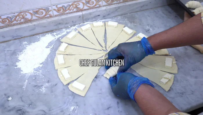 Fold the dough to create a half-moon shape. (170.64)