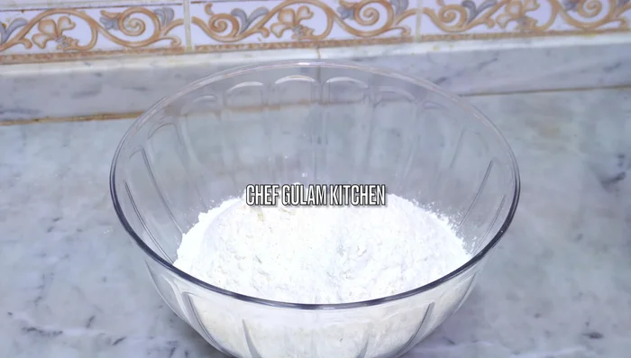 Add the wet ingredients to the flour. Gradually add 200 ml of water, mixing to form a soft dough. Knead for 10-12 minutes until smooth and elastic. (74)