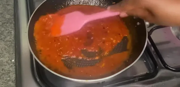 Add 3 tbsp tomato sauce, mix, and cook for 1 minute.