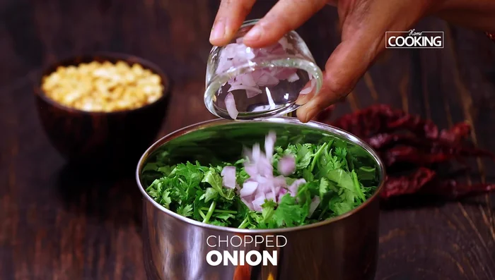 Make mint-coriander chutney by blending mint leaves, coriander leaves, chopped onion, ginger, green chili, black salt, cumin powder, and lemon juice.