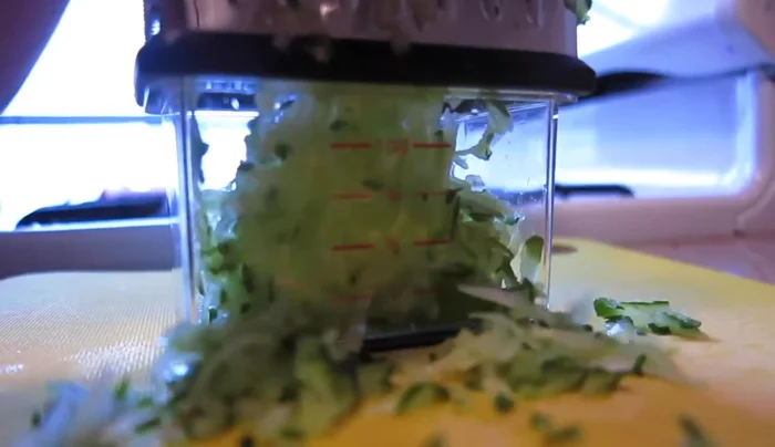 Shred ½ cucumber and strain it to remove excess water.