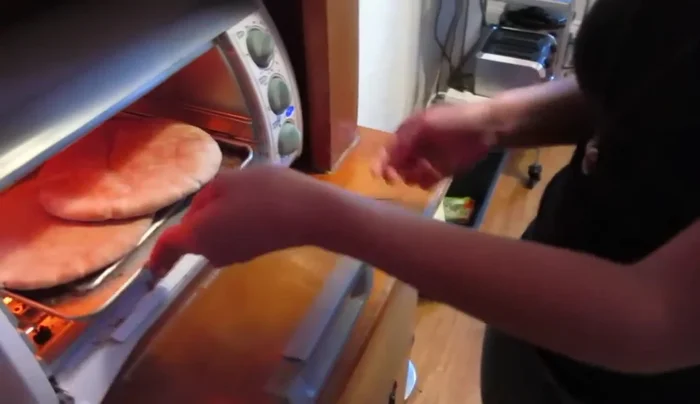 Warm the pita pockets.