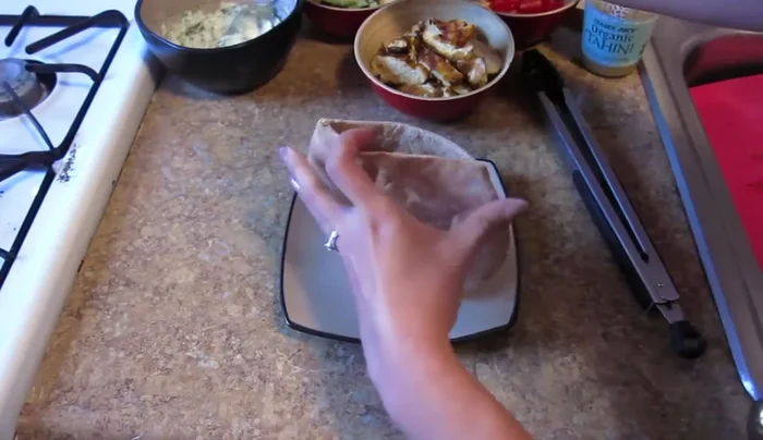 Spread tzatziki sauce on the inside of the pita pockets.
