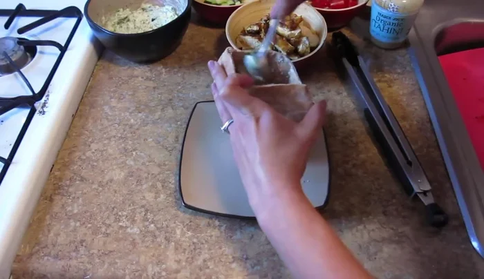 Add the grilled chicken shawarma to the pita pockets.