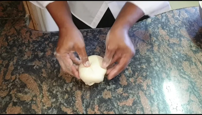 Divide the dough into four equal pieces. Roll each piece into a small ball, then flatten into a small roti.
