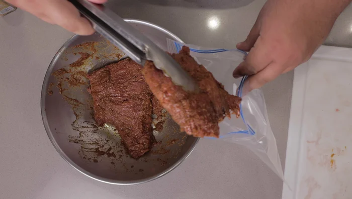 Transfer the marinated meat to a gallon-size zip top bag. (This helps prevent staining and saves space in the fridge).