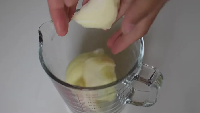 Add one whole medium onion and garlic cloves to a jug.