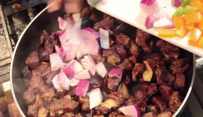 Add chopped onions and bell peppers (optional) to the pan. Mix well.