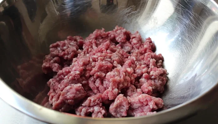 Prepare the stuffing: Combine ground lamb, unrinsed long grain rice, olive oil, currants, pine nuts, salt, black pepper, cumin, a pinch of cinnamon, dried oregano, and chopped fresh mint. Mix thoroughly with a fork and refrigerate.