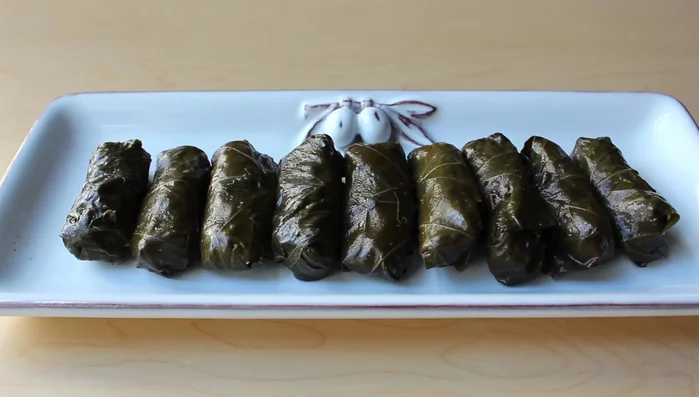 Serve: Once cooked, arrange the dolmas on a platter. Garnish with lemon zest, fresh lemon juice, and a drizzle of olive oil. Serve warm or at room temperature. Optional: Serve with yogurt sauce.