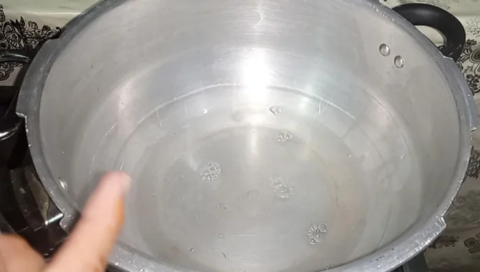 Add about 1.5 cups of water to a cooker. Place a glass or steamer rack inside to create a steaming area.
