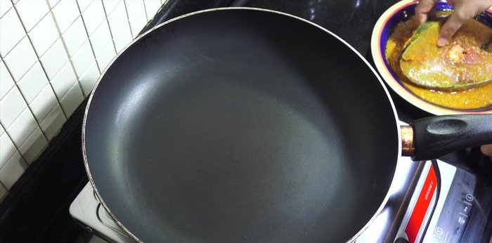 Heat a dry pan over a low heat. Add the fish and fry gently, flipping it three or four times.