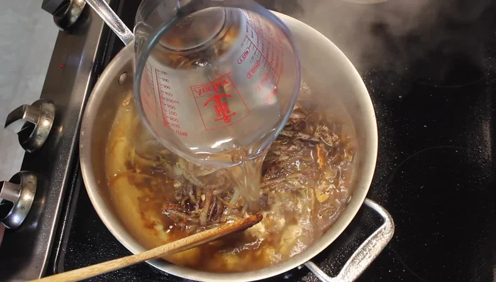 Add 3 cups of water to the pan, scraping the bottom to get all the fond. Add the cooked chicken back to the pan and submerge it in the water.