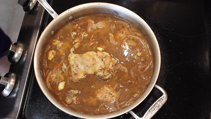 Add half of the chopped pine nuts to the pan. Simmer for 30 minutes with the lid on.