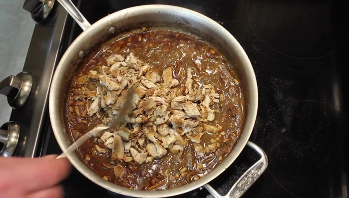 Add the shredded chicken back to the pan, turn off the heat. Stir in the remaining pine nuts and parsley.