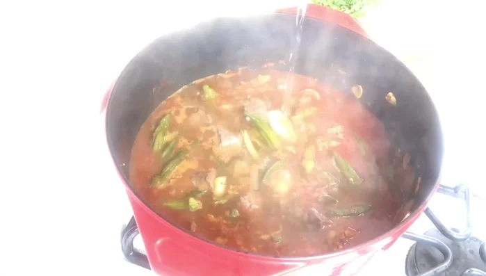 Add the chopped cilantro, cover the pot, and transfer to a preheated oven at 325°F (160°C) for 1-1.5 hours.