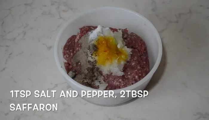 Prepare meatballs: Mix ground meat, grated onion, salt, pepper, and dissolved saffron. Roll into small meatballs.