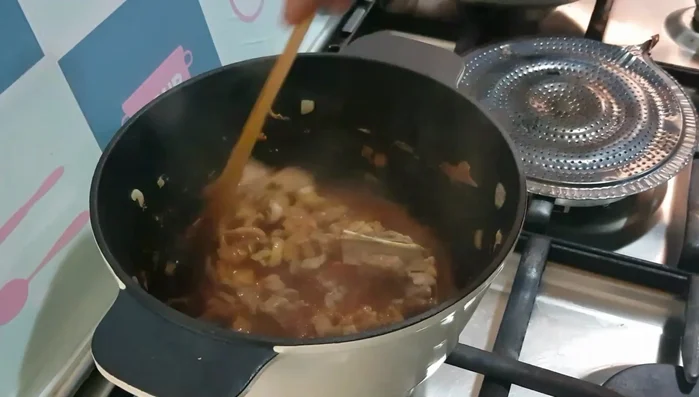 Add tomato paste. Cook until oil separates, then add water. Simmer (covered) for 5 minutes.