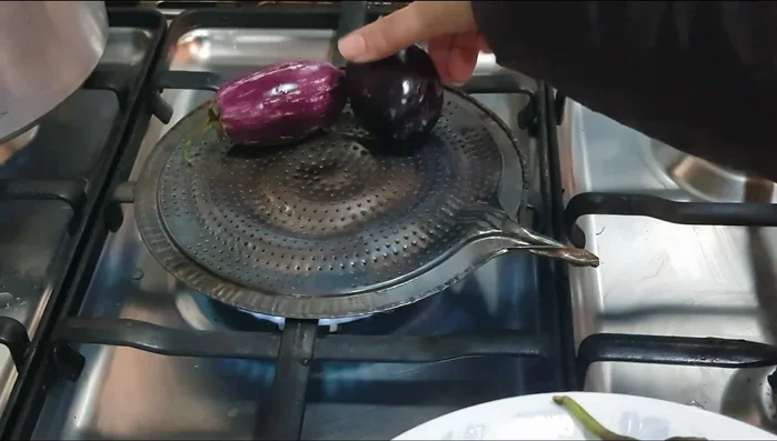 Roast eggplants (50-60 minutes) until skin is charred and flesh is soft. Use a perforated pan or any pan of your choice.