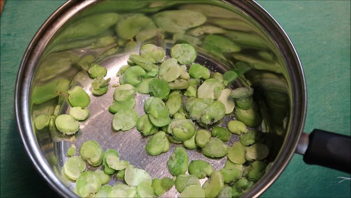 Add one cup of broad beans and two cups of water to a saucepan.