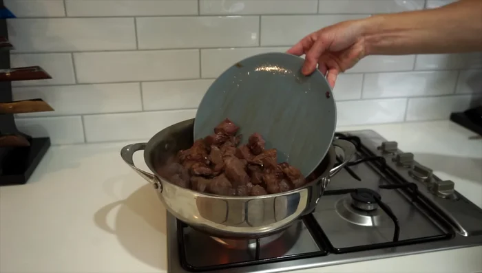 Return beef and add aromatics: Add the browned beef, cinnamon sticks, cloves, and bay leaves. Bring to a boil, then reduce heat to low, cover, and simmer for 1 hour.