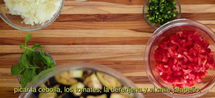 Chop onion, tomatoes, eggplant, and jalapeno chili.