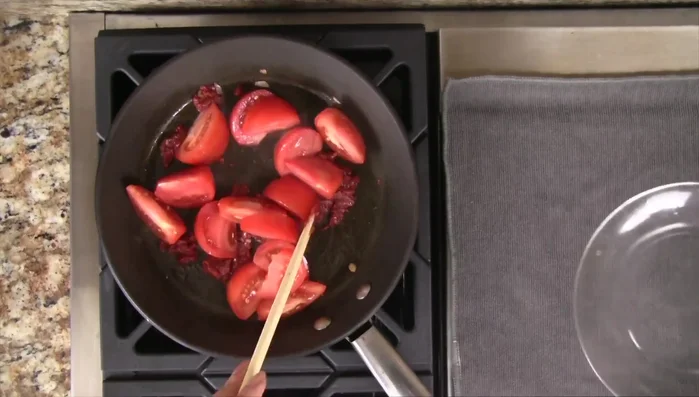 Add the tomatoes to the skillet and stir until they soften (2-3 minutes). Remove from heat and set aside.