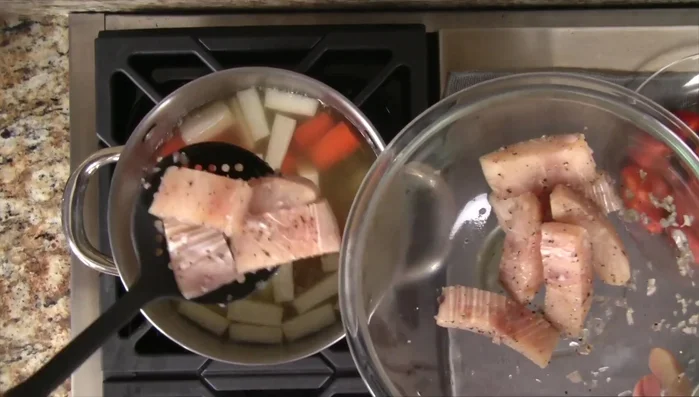 Add the marinated fish to the soup. Bring to a boil again, then reduce heat to medium and cook for 5 minutes, skimming off any foam.