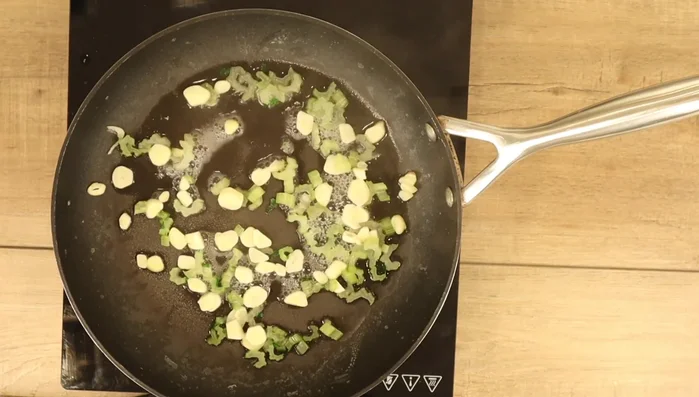 Add garlic and Swiss chard leaves: Add the sliced garlic to the saucepan. Stir in the Swiss chard ribbons. Cook for another 5 minutes, or until the leaves are wilted.